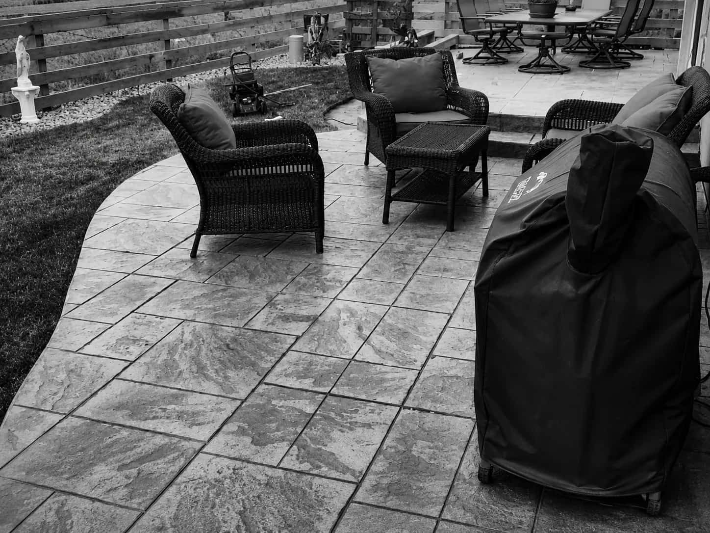 Stamped concrete patio with outdoor furniture built by an outdoor living contractor